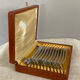 Art Deco oyster forks in punched silver metal, leatherette box