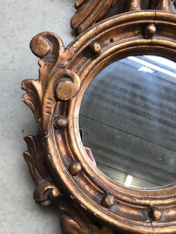 Miroir en bois doré Empire à décor d’aigle 40x97cm