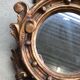 Miroir en bois doré Empire à décor d’aigle 40x97cm