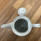 Vintage coffee pot in white porcelain with a gold trim.