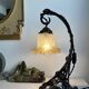 Art Nouveau wall light in wrought iron with vine decoration, early 20th century.
