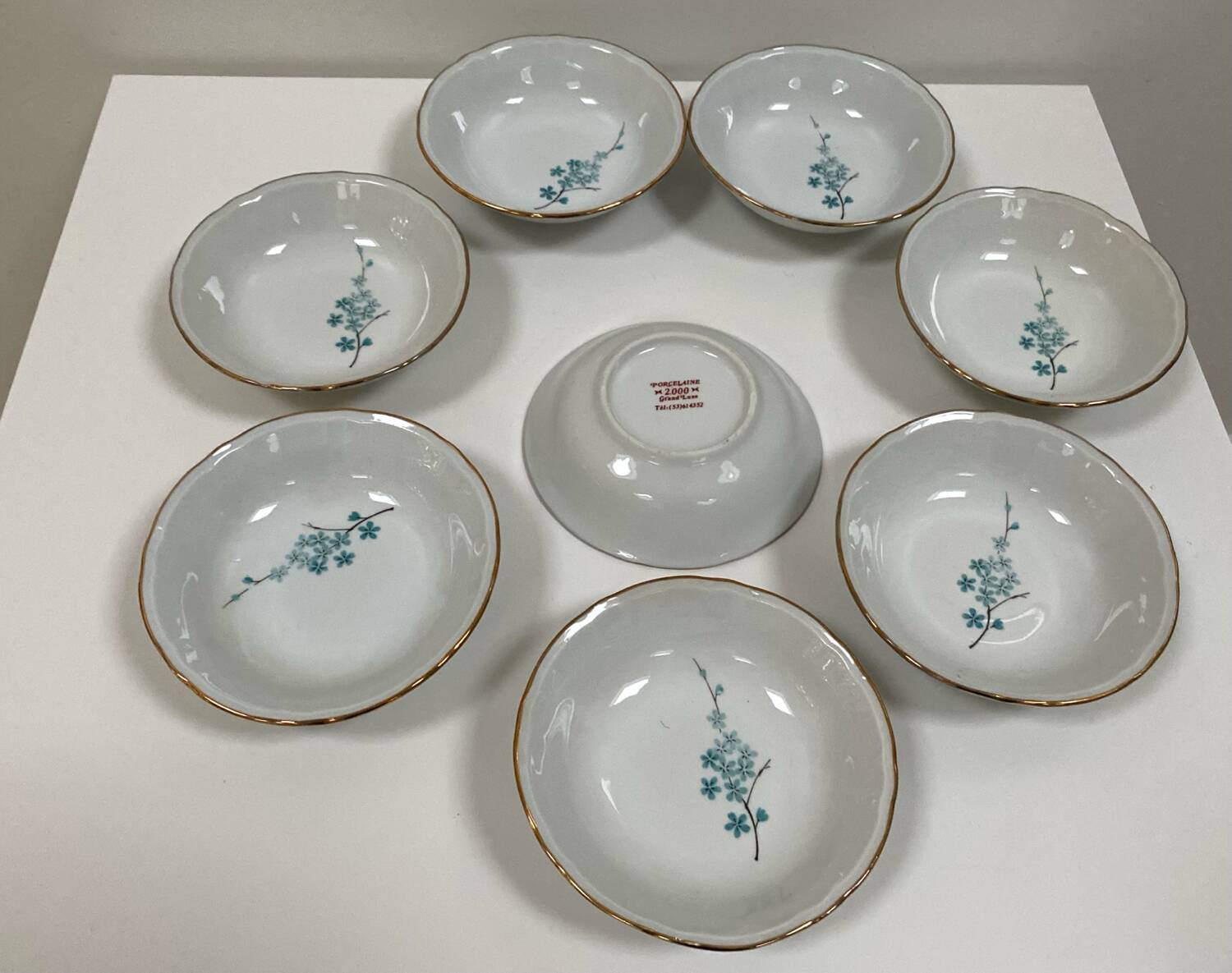 Vintage porcelain service: salad bowl and 8 small bowls.