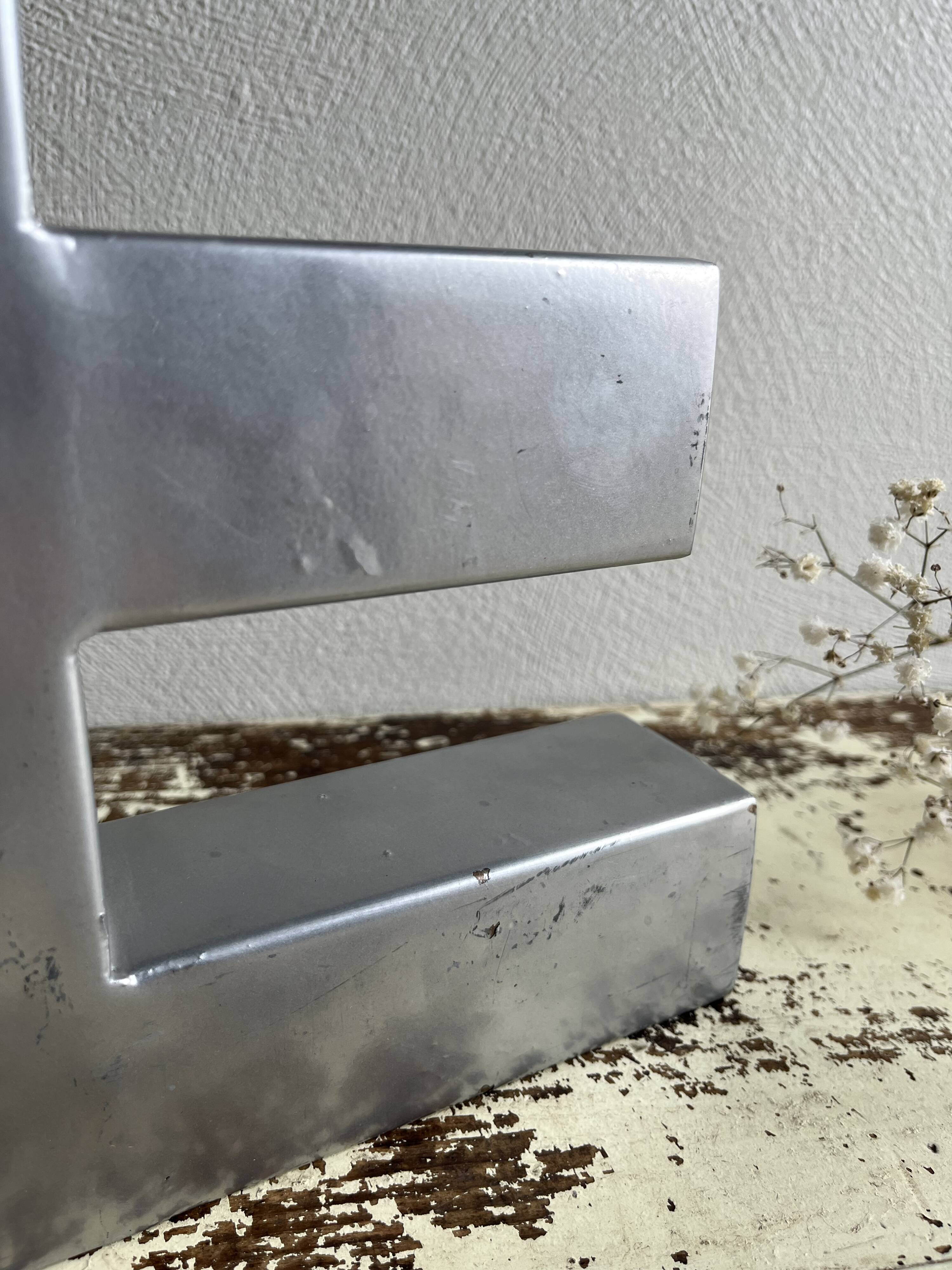 Metal sign letter E