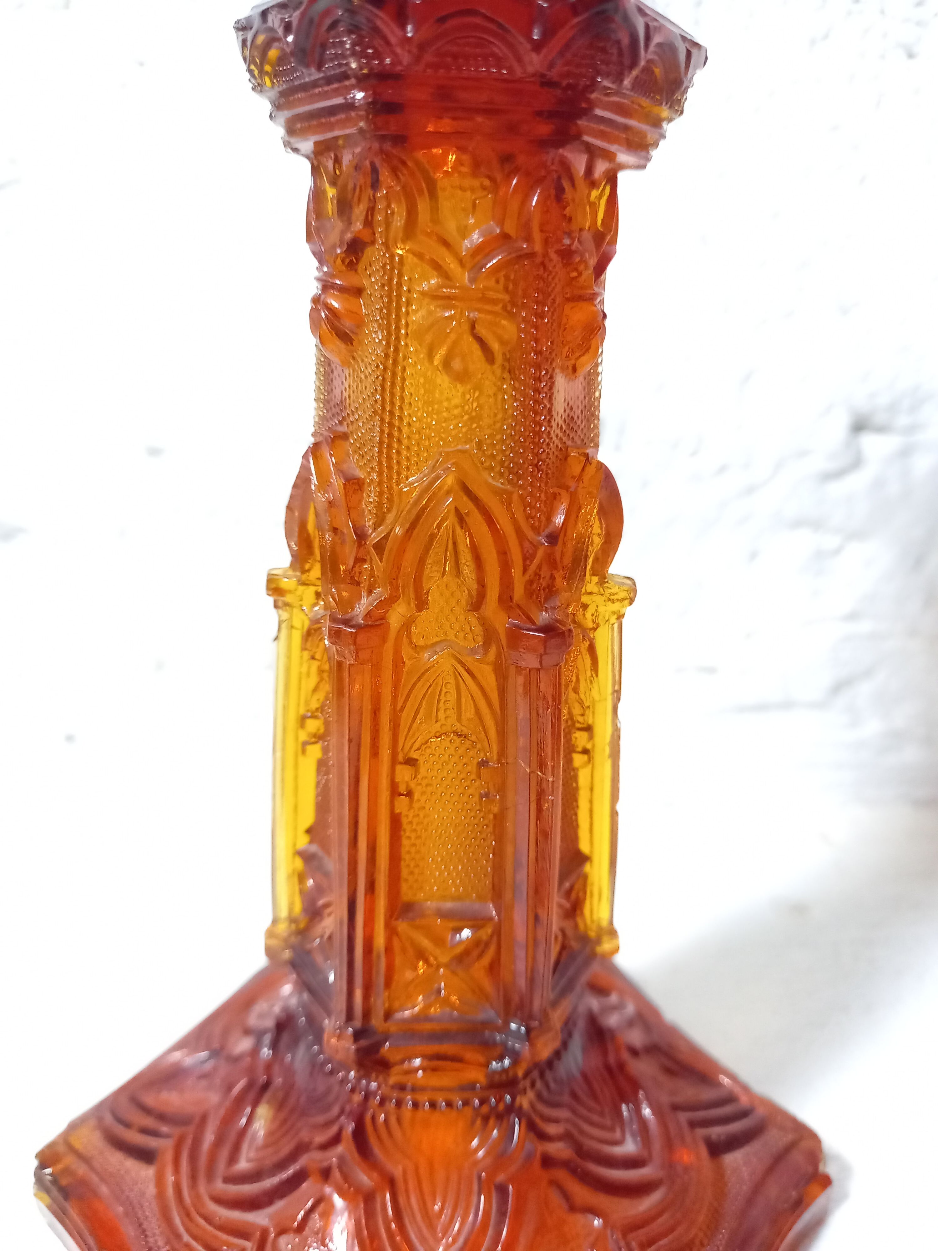 Pair of amber glass torches decorated with gothic motifs