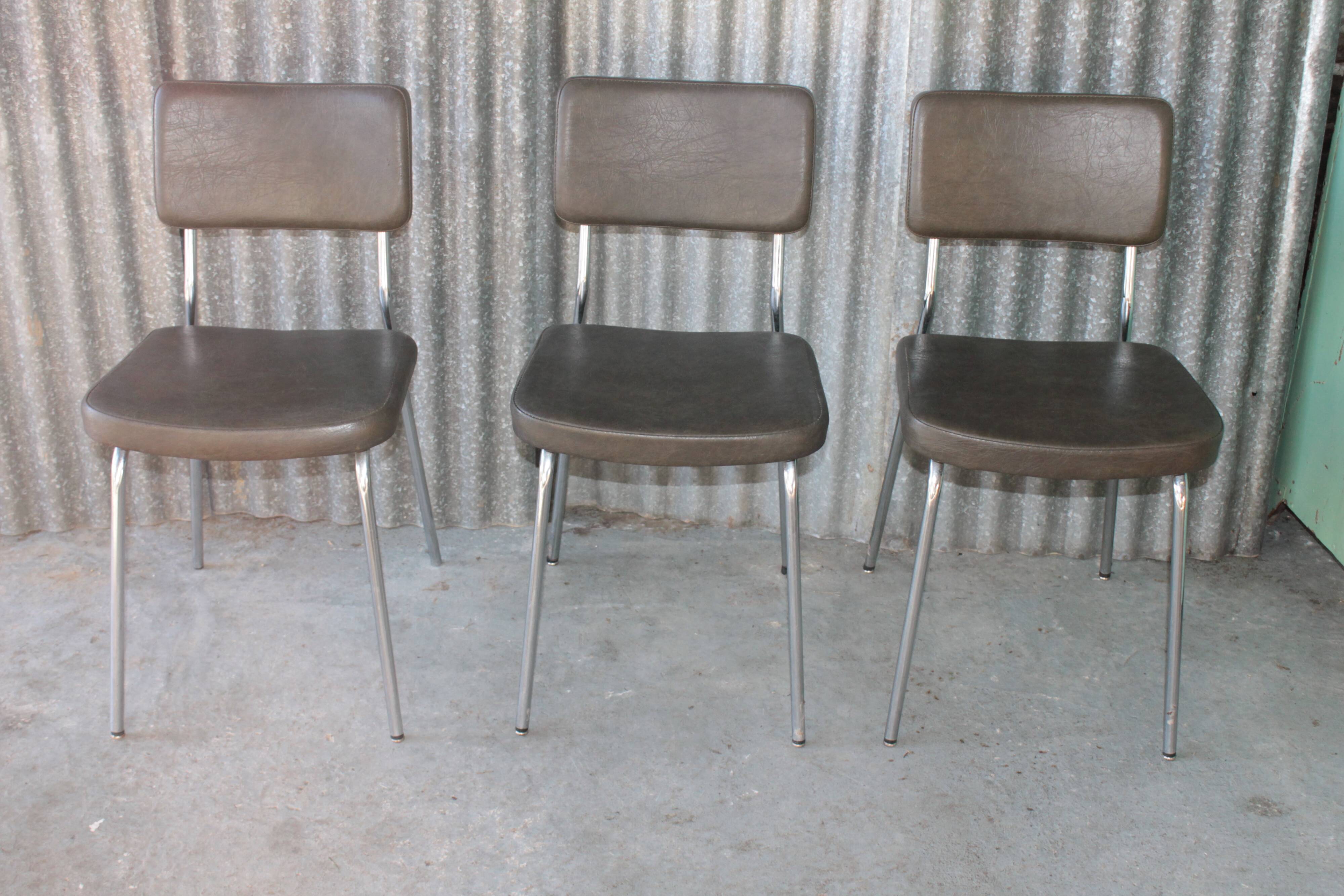 3 bronze-green faux leather chairs with chrome frames