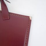 Mirror covered in burgundy leather