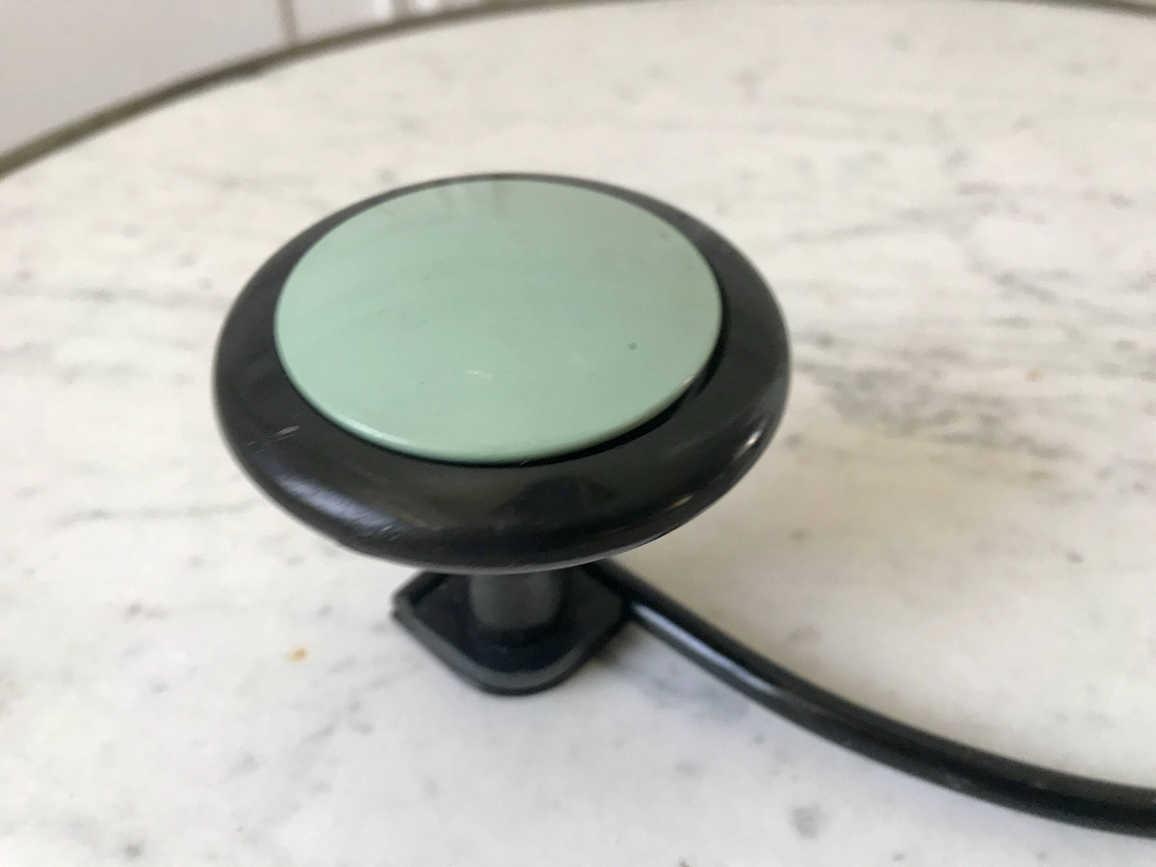 Design coat hook in sage green and black metal from the 70s
