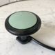 Design coat hook in sage green and black metal from the 70s