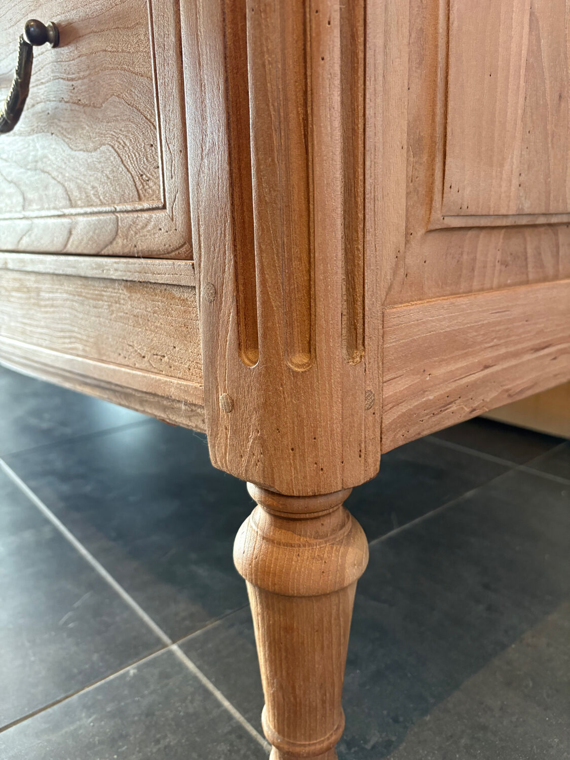Cherry wood commode with a raw wood finish.