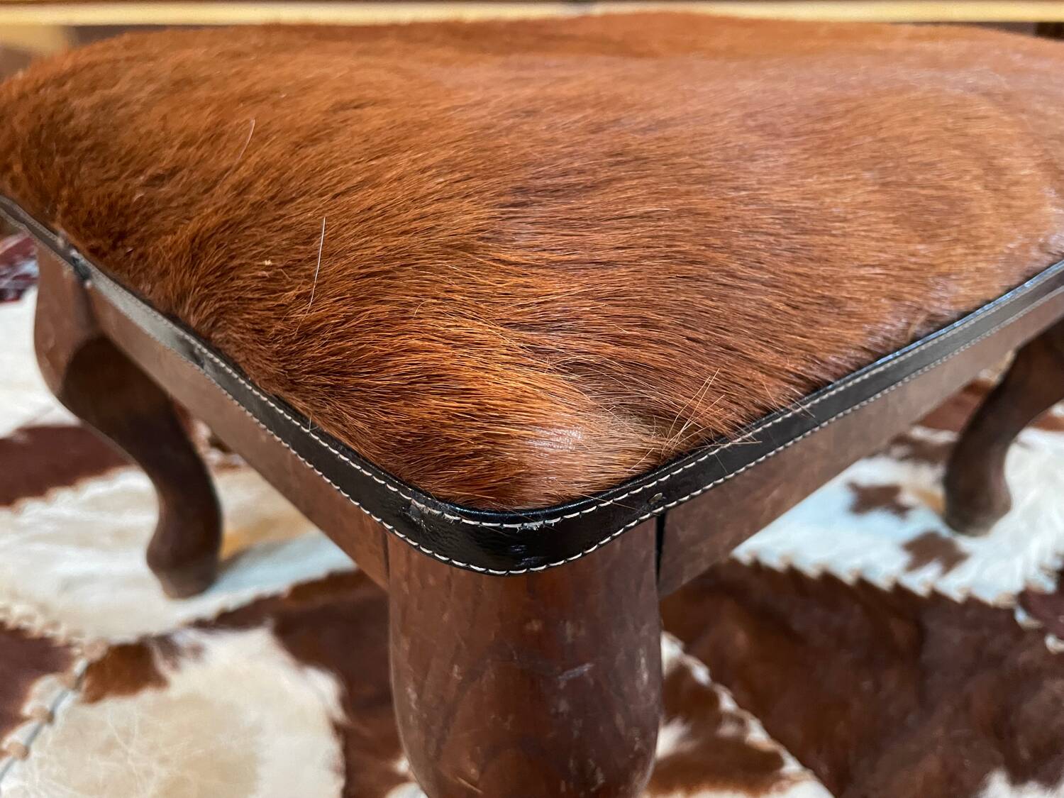 Vintage wooden and goatskin pouf