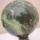Stair railing ball in enameled cast iron imitating veined green, sea green marble.