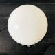 Handcrafted wrought iron lamp with a white opaline globe.