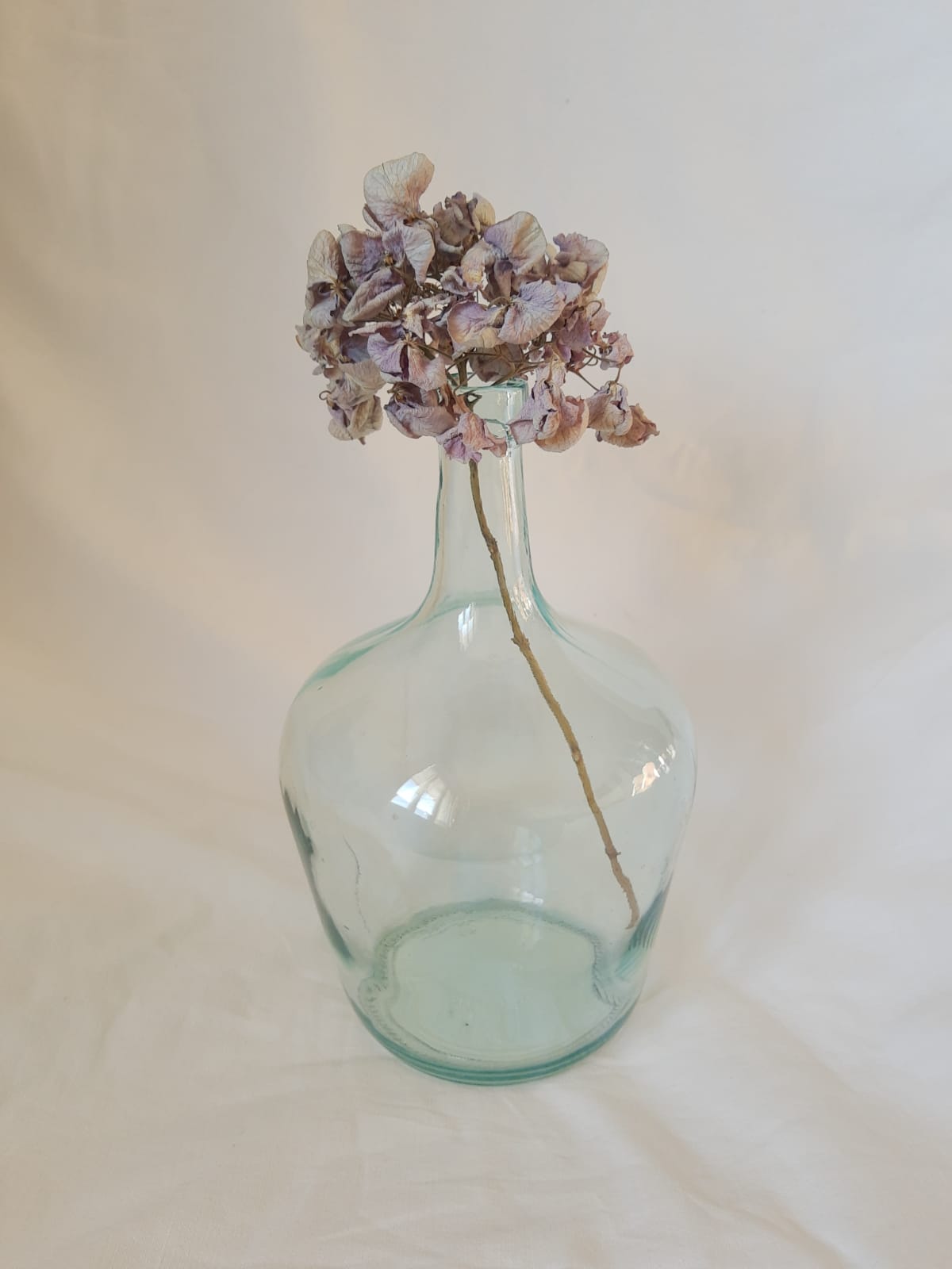 Demijohn in vintage transparent glass