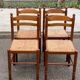 4 dining or kitchen chairs made of solid wood with rush seats.