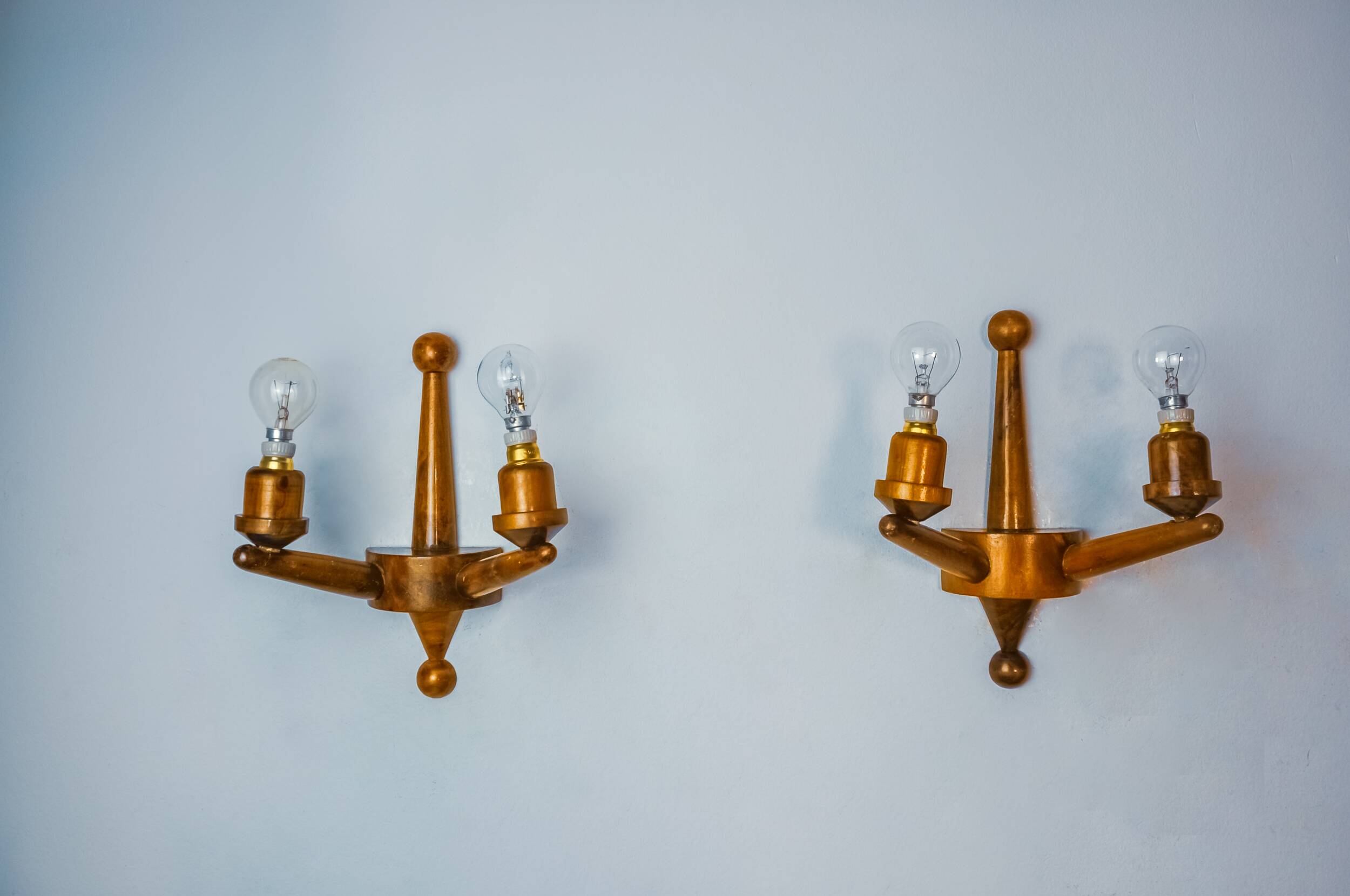 Pair of two-armed art deco wall lights, carved wood, France, 1960