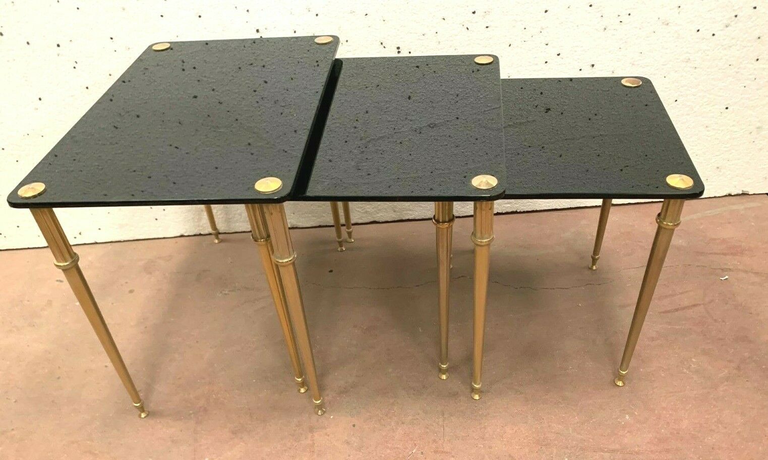 Pull out tables in brass and black glass XX century