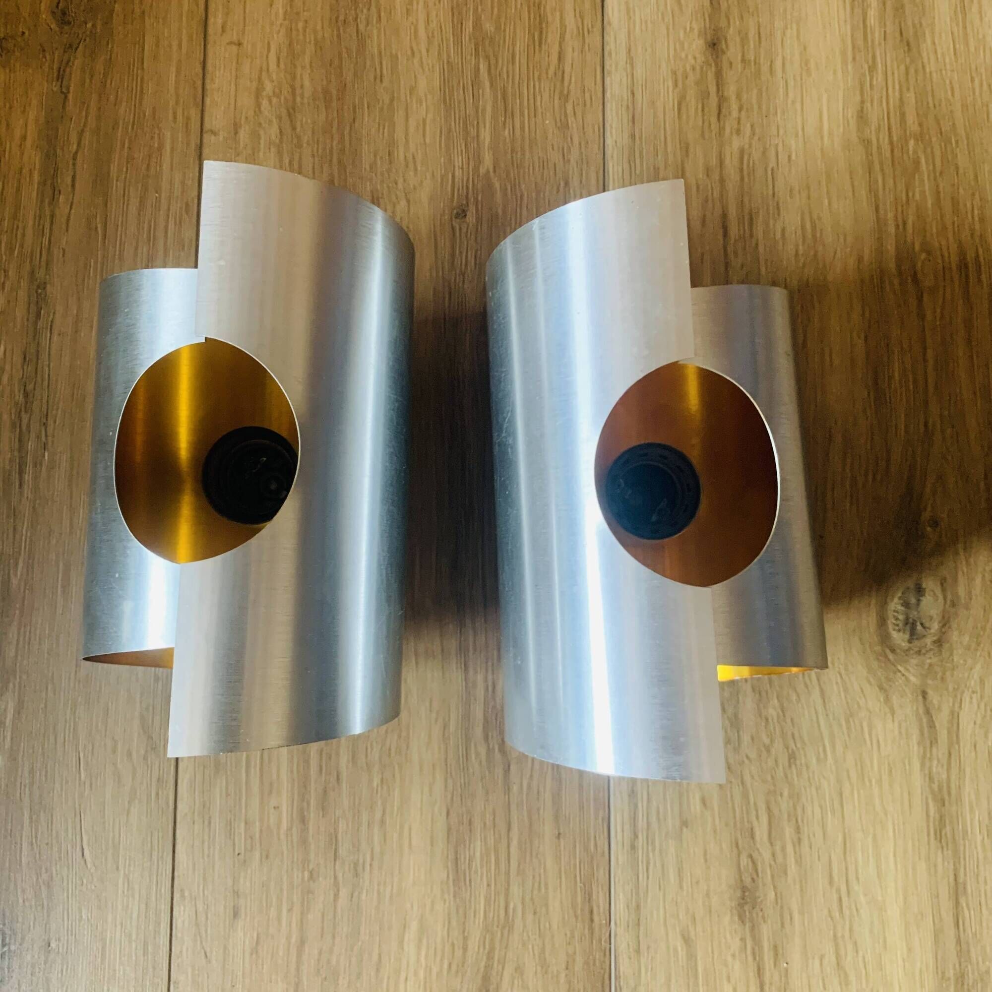 Pair of Space Age wall lights in brushed metal with a copper-orange interior.