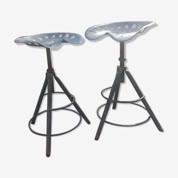 Two tractor-style industrial stools