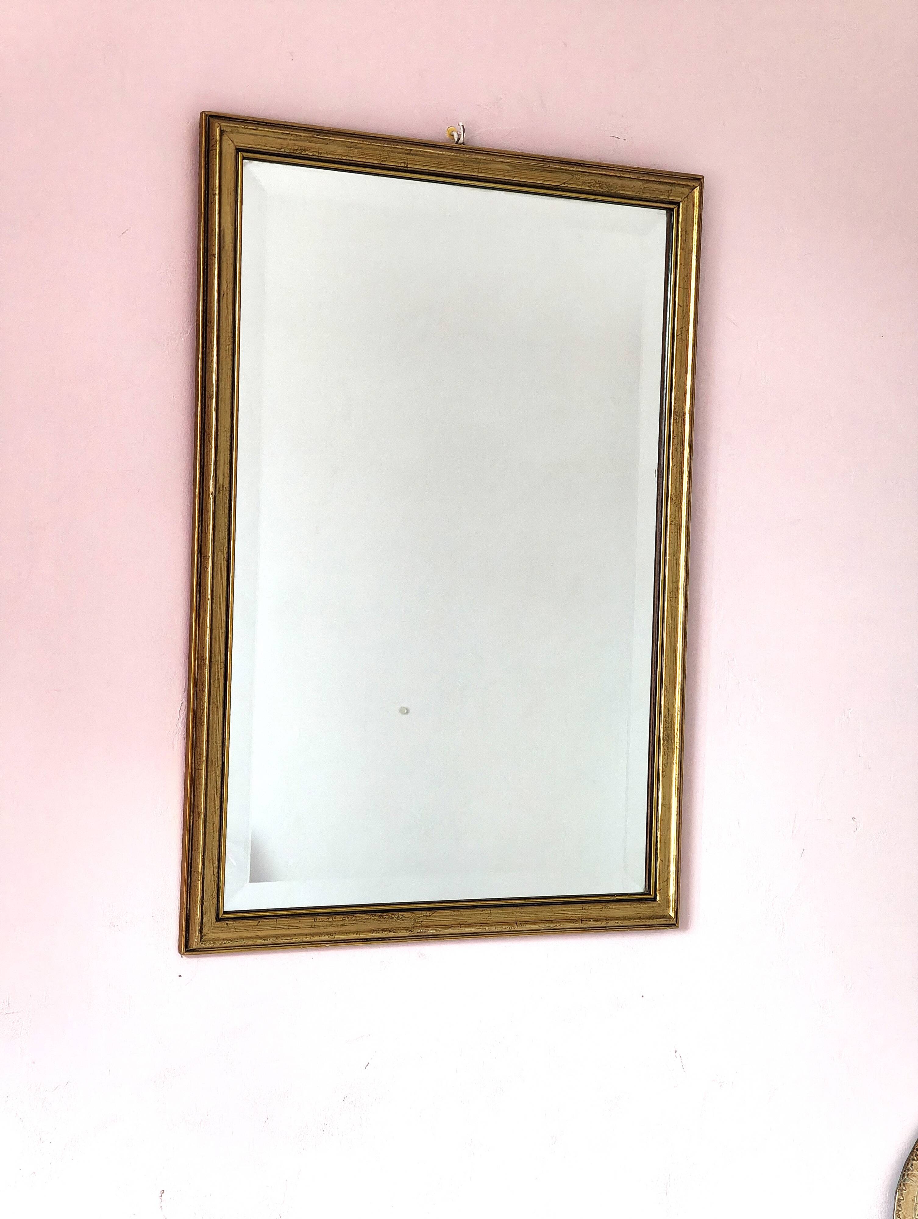 Rectangular gold mirror with bevelled glass.