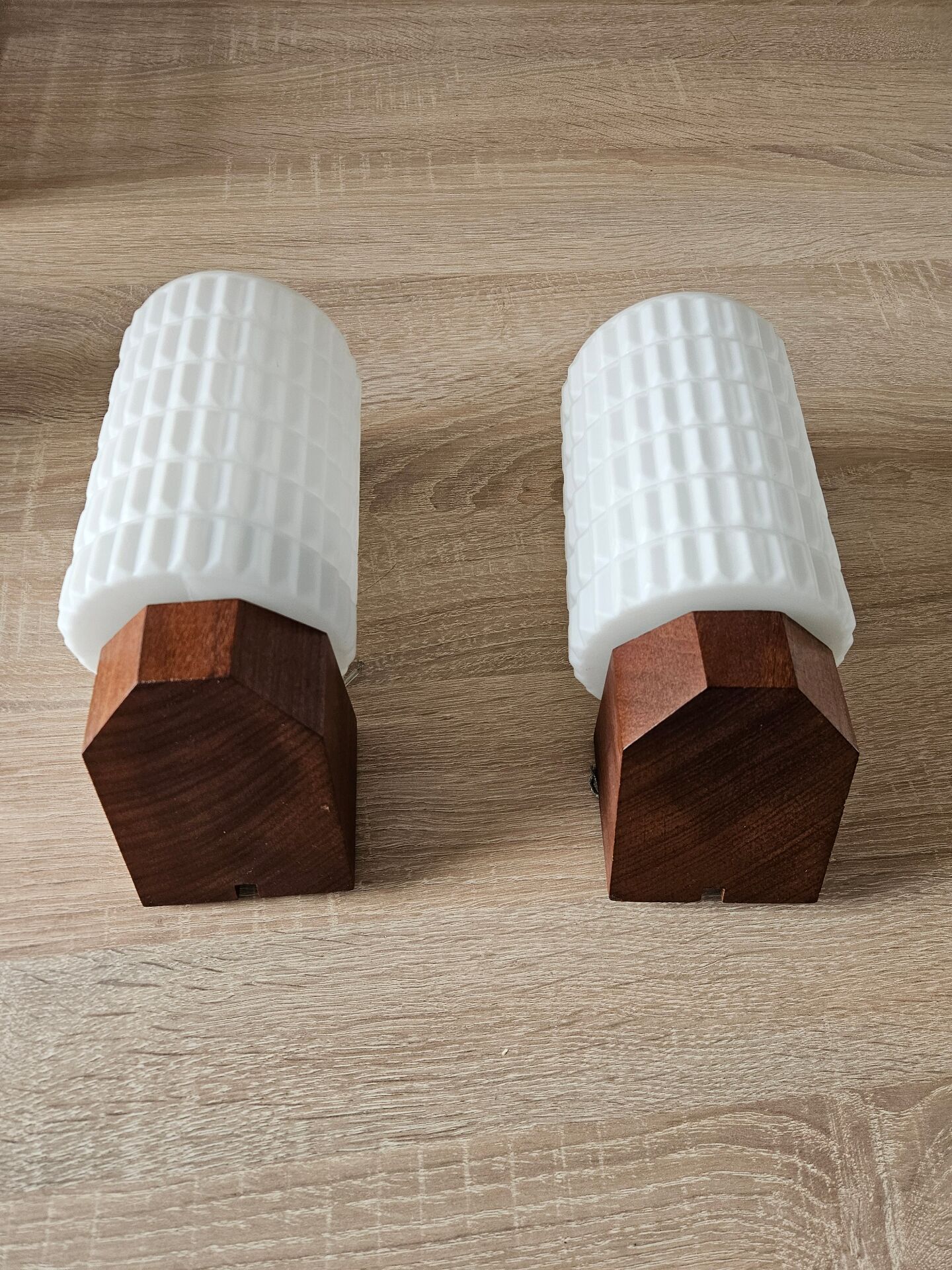 Philips wall sconces in wood and white opal.
