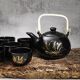 Japanese tea service, teapot and 6 cups, black, gold pattern.