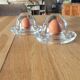 2 egg cups with matching glass cloches in transparent glass