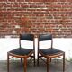 Set of 2 vintage Scandinavian chairs in wood and black faux leather.