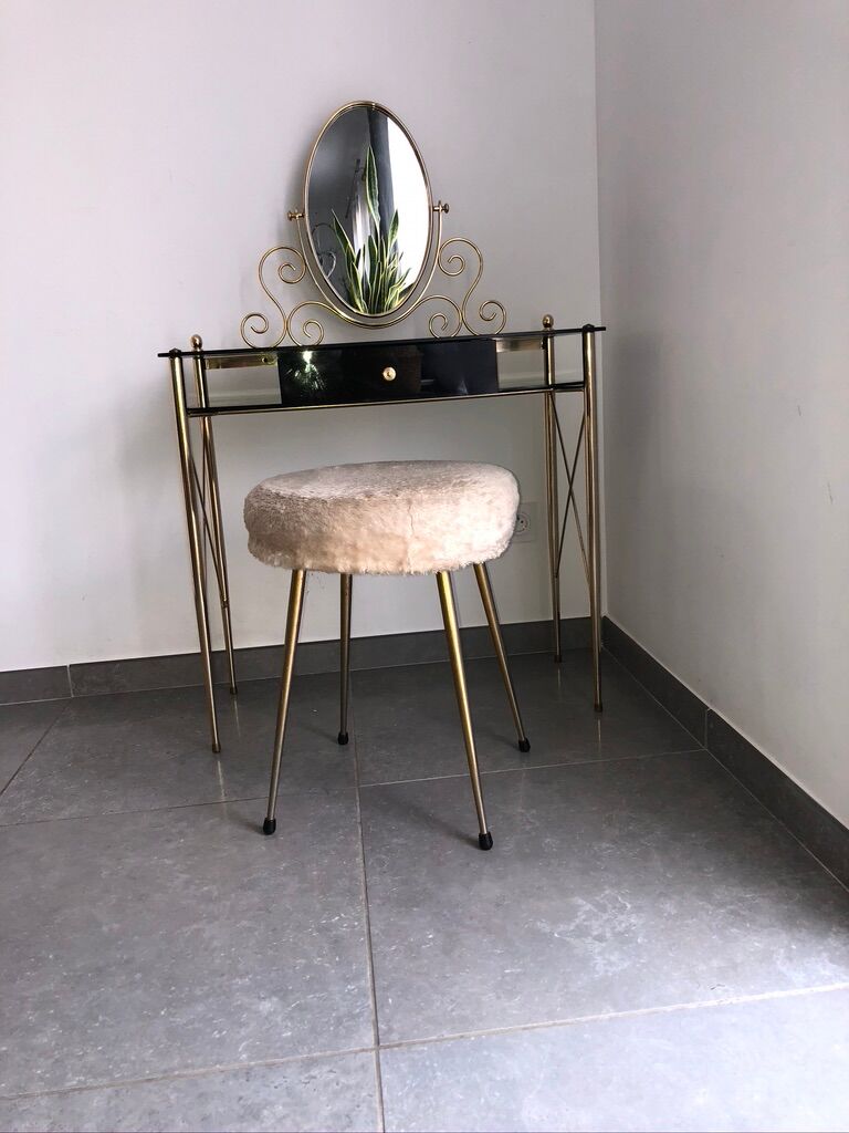 Brass hairdresser, glass and black plastic with its fluffy stool.