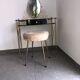 Brass hairdresser, glass and black plastic with its fluffy stool.