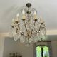 Lustre with 10 arms of light, antique with crystal pendants.