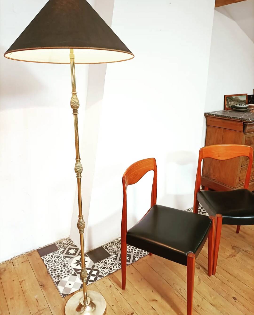 Bronze floor lamp with pine cone decoration.
