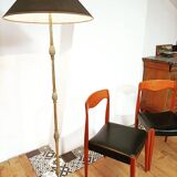 Bronze floor lamp with pine cone decoration.