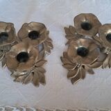 An antique pair of candlesticks with a floral design.