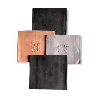 Set of four old damasked and monogrammed towels, tinted multiple colors