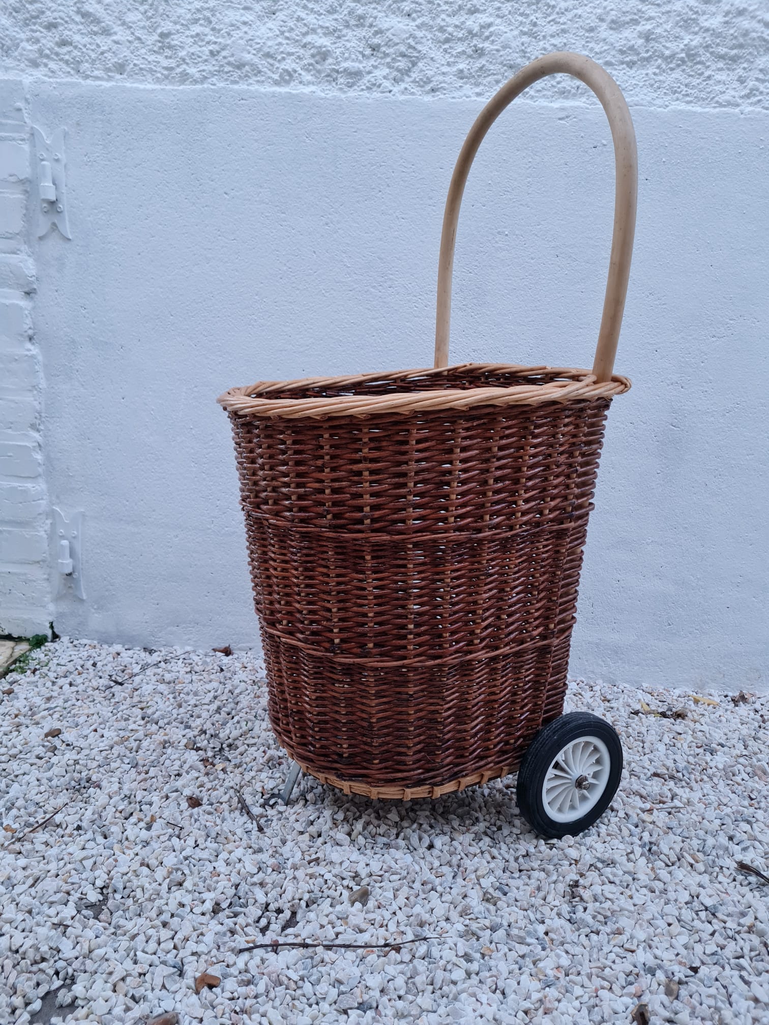 Vintage wicker log basket on vintage wheels