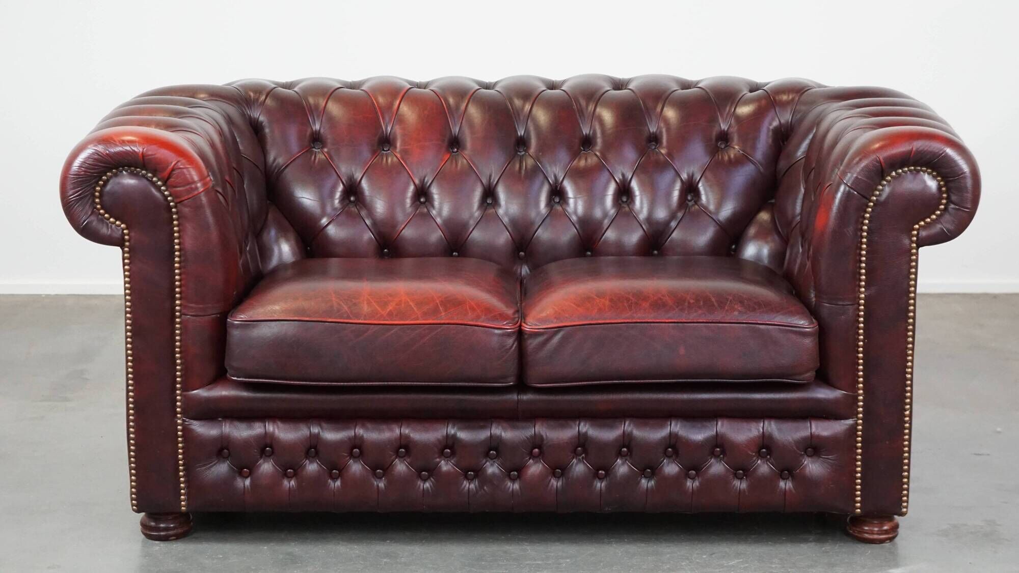 Original English Chesterfield sofa in red cowhide 2 seater