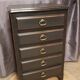 Cherry wood chest of drawers with 5 drawers in aged black.