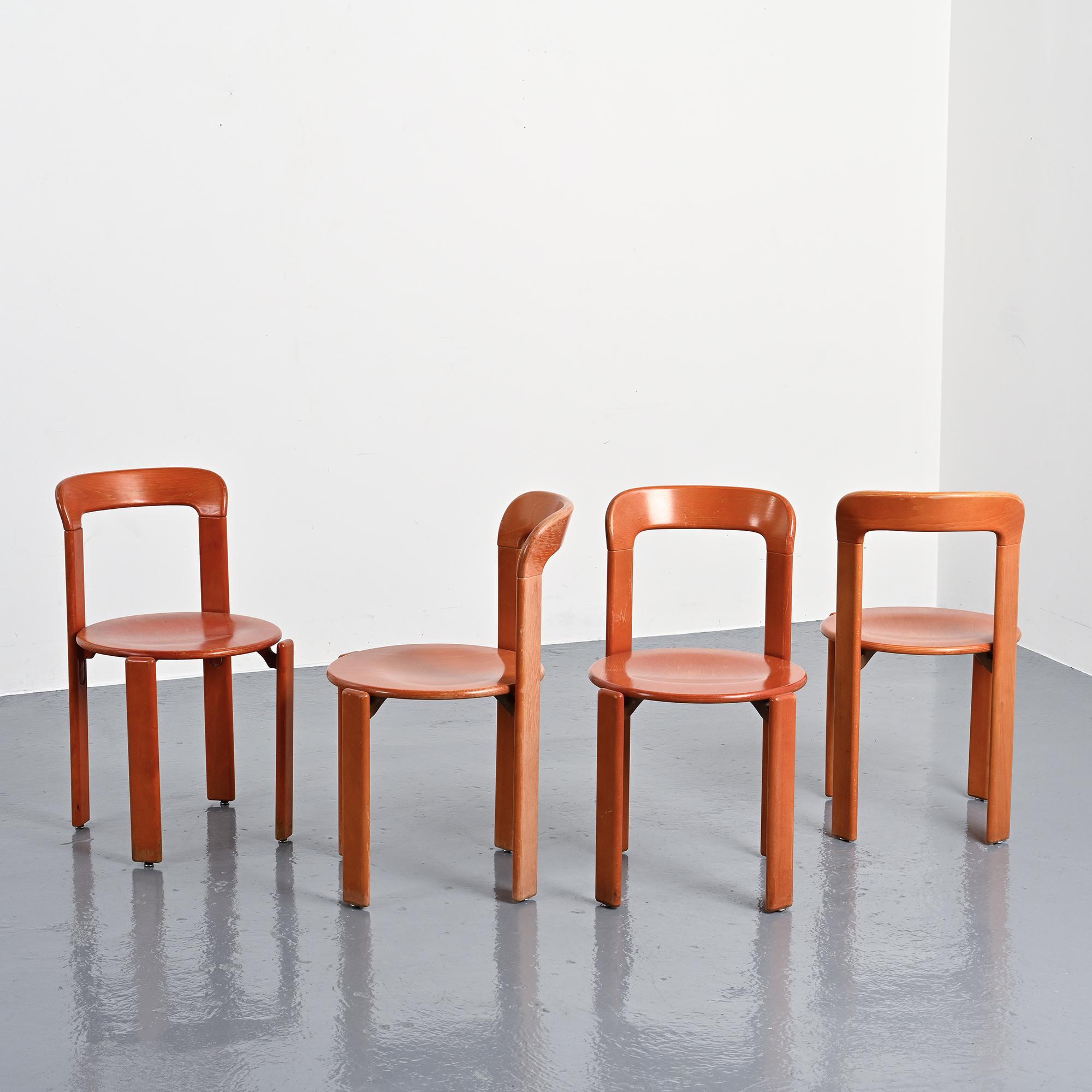 Rey chairs in stained red beech by Bruno Rey