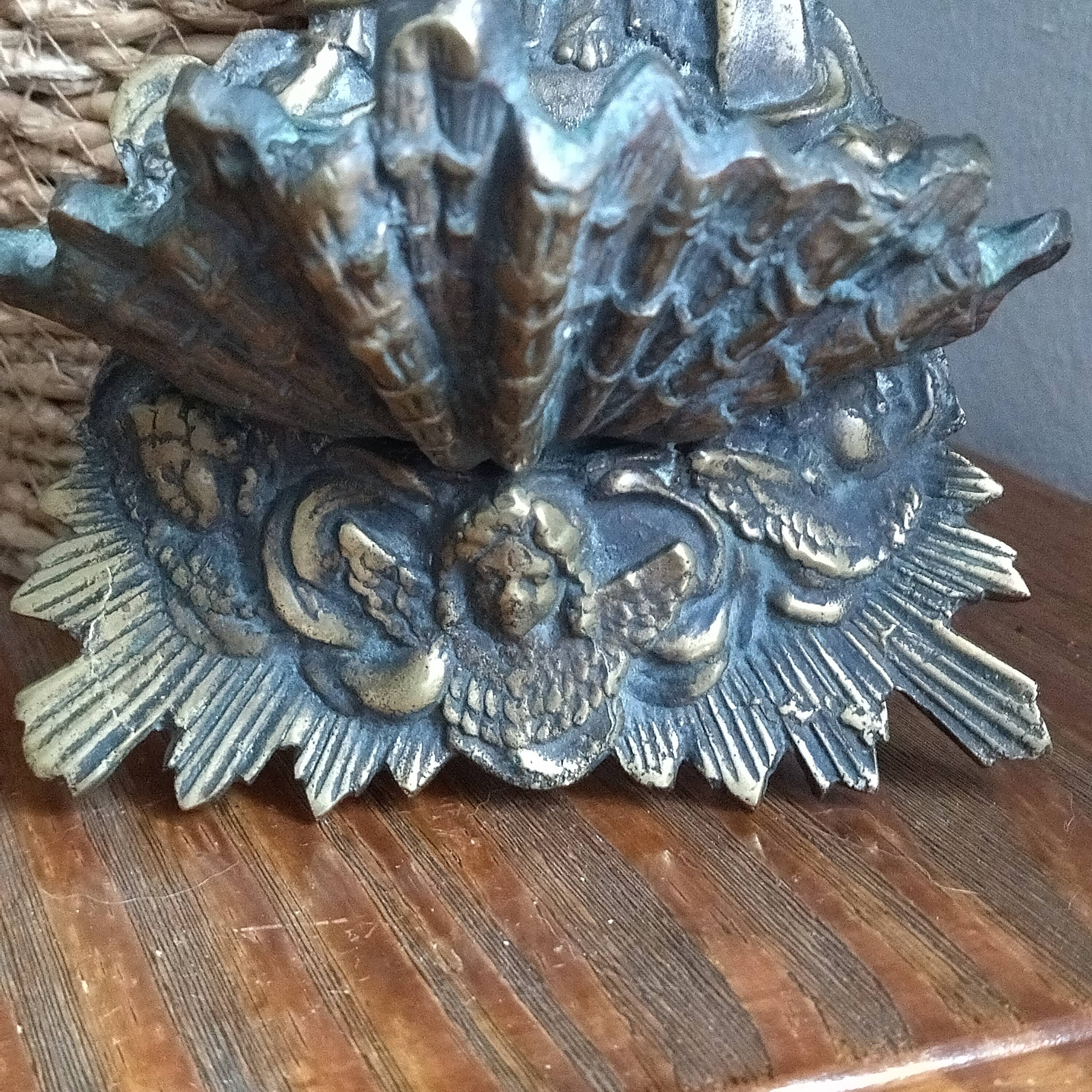 Antique bronze holy water font