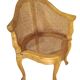 Armchair in solid oak with caning and a central leg (known as couillard), 89x68cm.