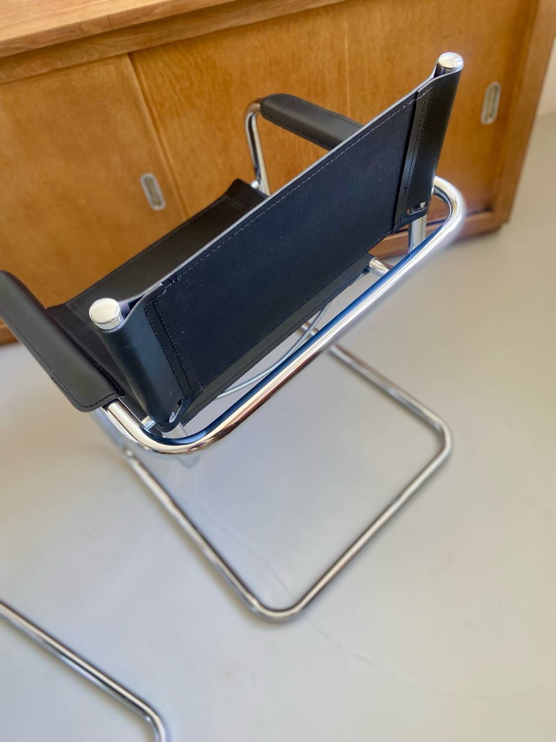 Pair of vintage chrome and black faux leather armchairs