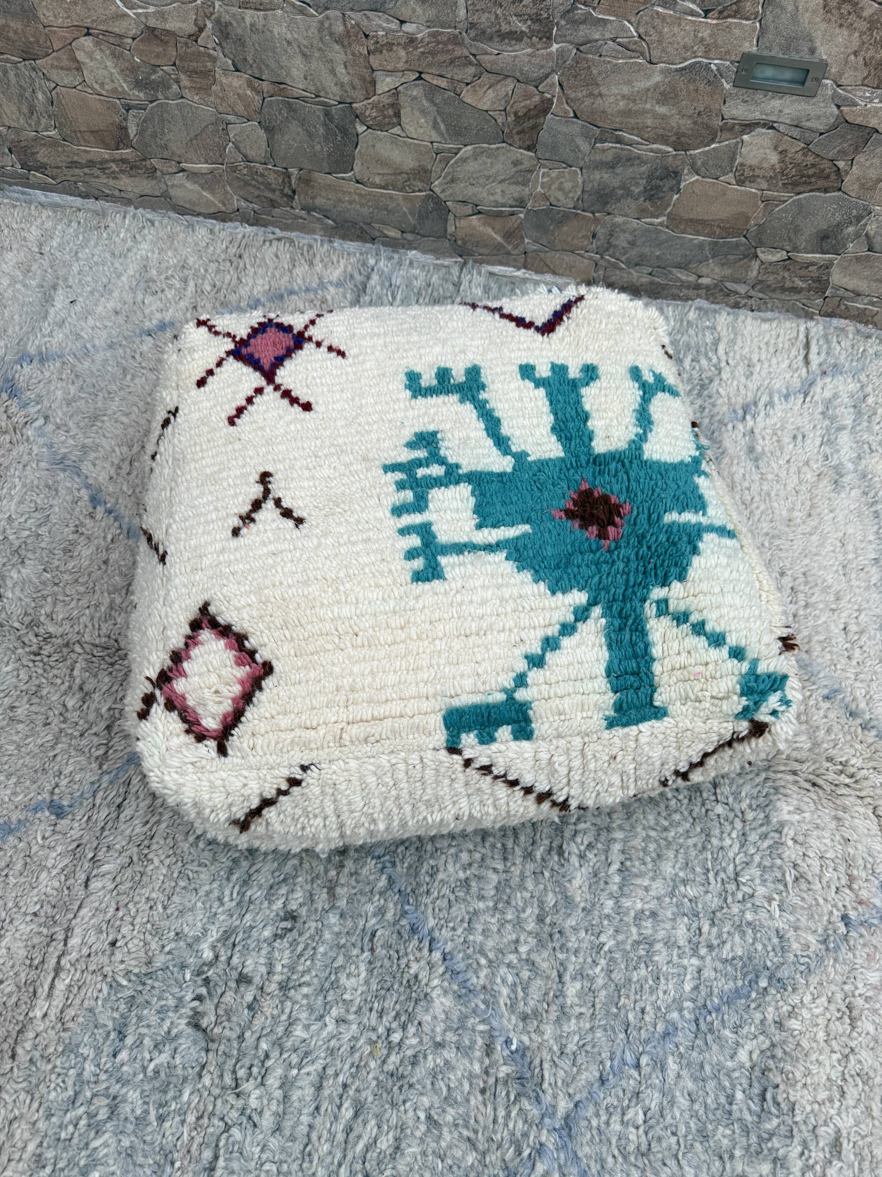 Berber floor pouf: Handwoven Moroccan wool cushion.