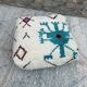 Berber floor pouf: Handwoven Moroccan wool cushion.