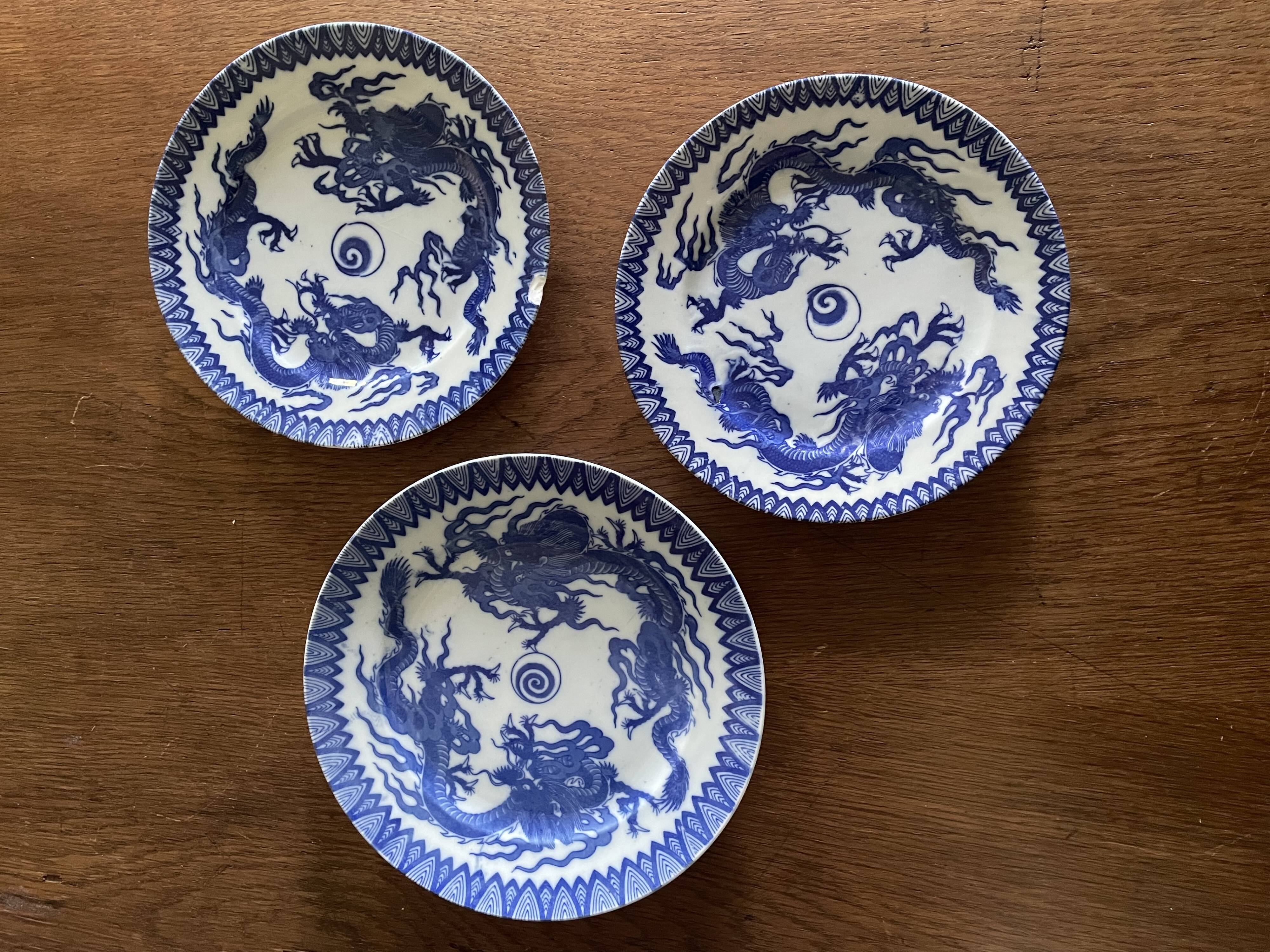 Asian porcelain plates decorated with blue dragons