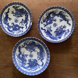 Asian porcelain plates decorated with blue dragons
