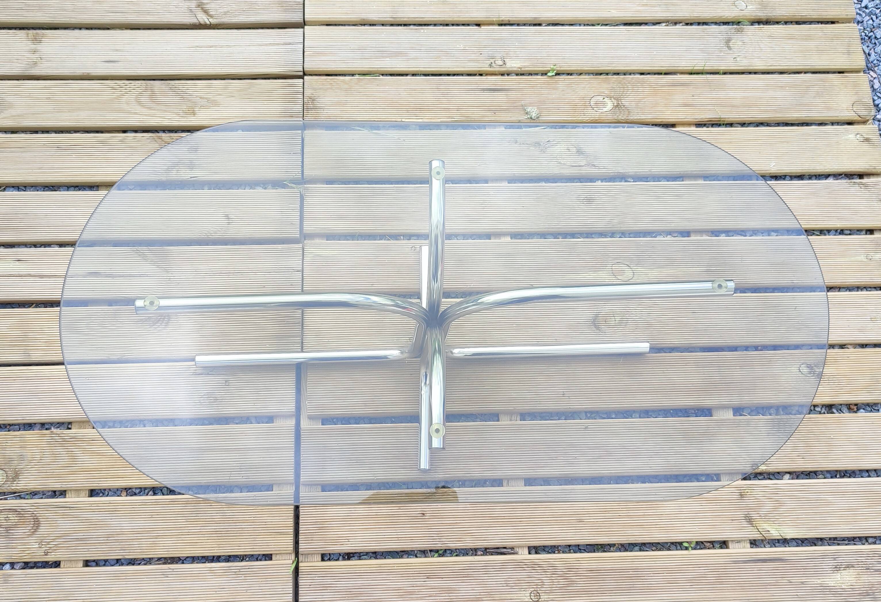 Vintage coffee table with metal tube structure and glass top.