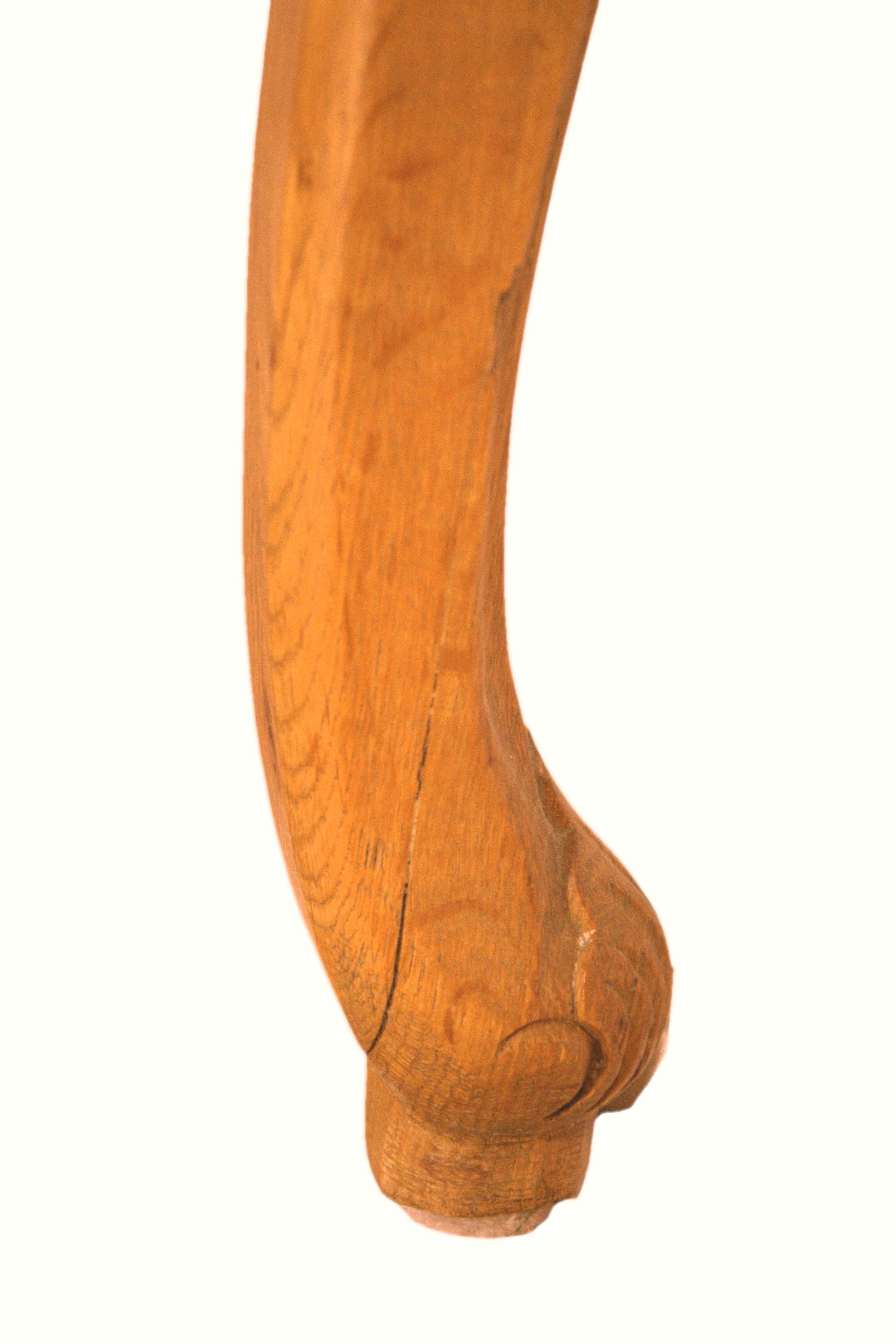 Armchair in solid oak with caning and a central leg (known as couillard), 89x68cm.