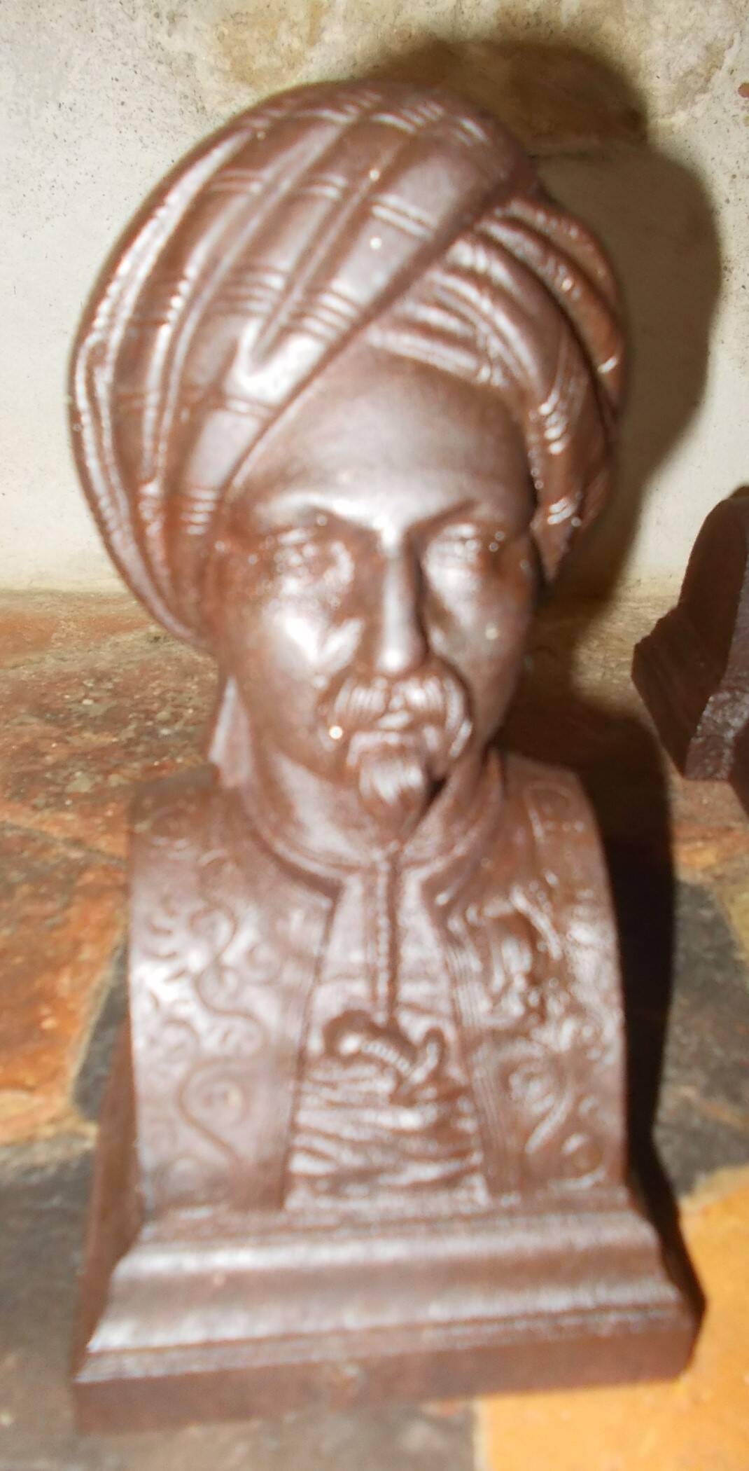 Old cast iron andirons with oriental decor