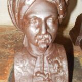 Old cast iron andirons with oriental decor