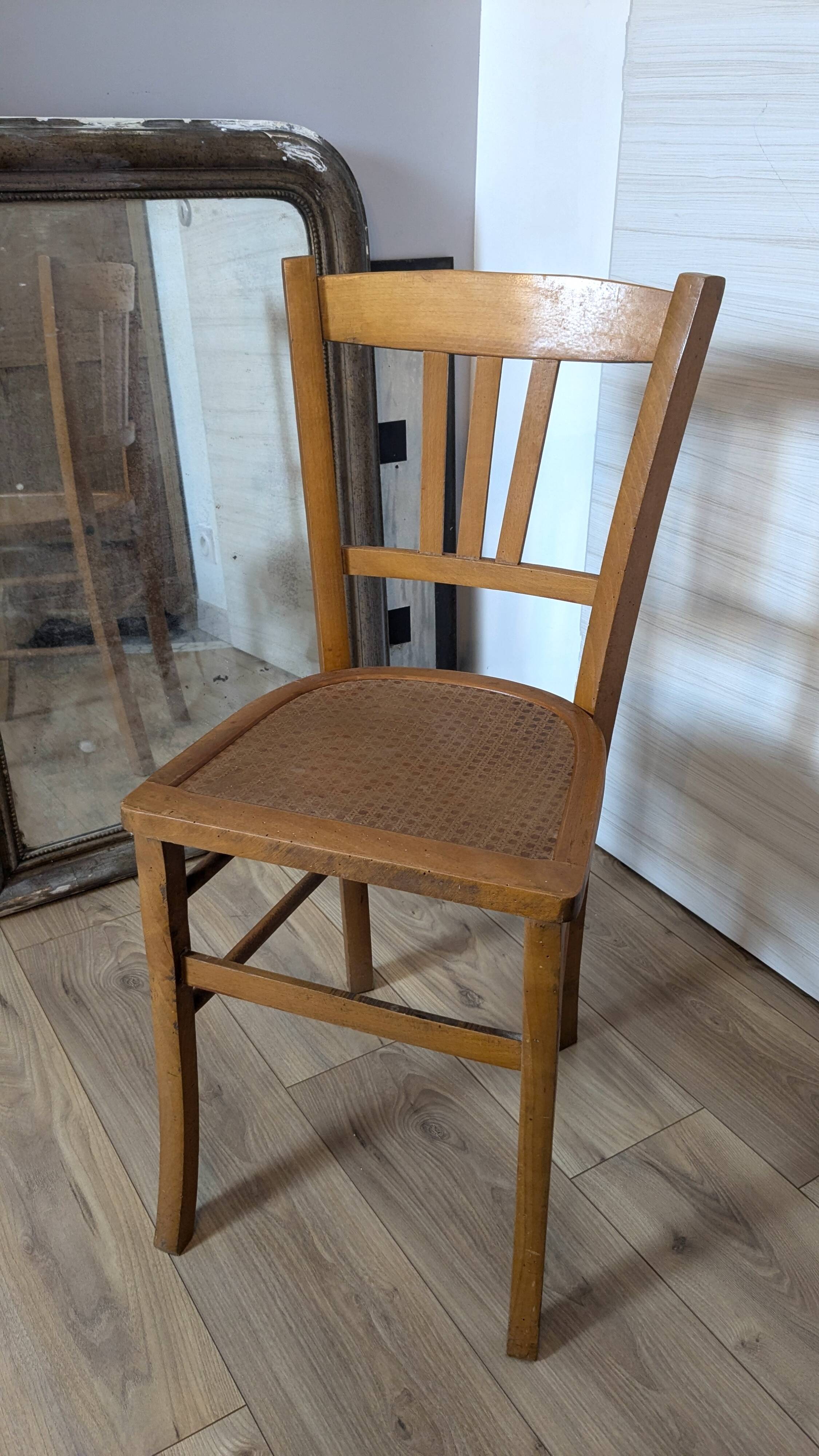 Antique patinated wooden bistro chair from the early 20th century.